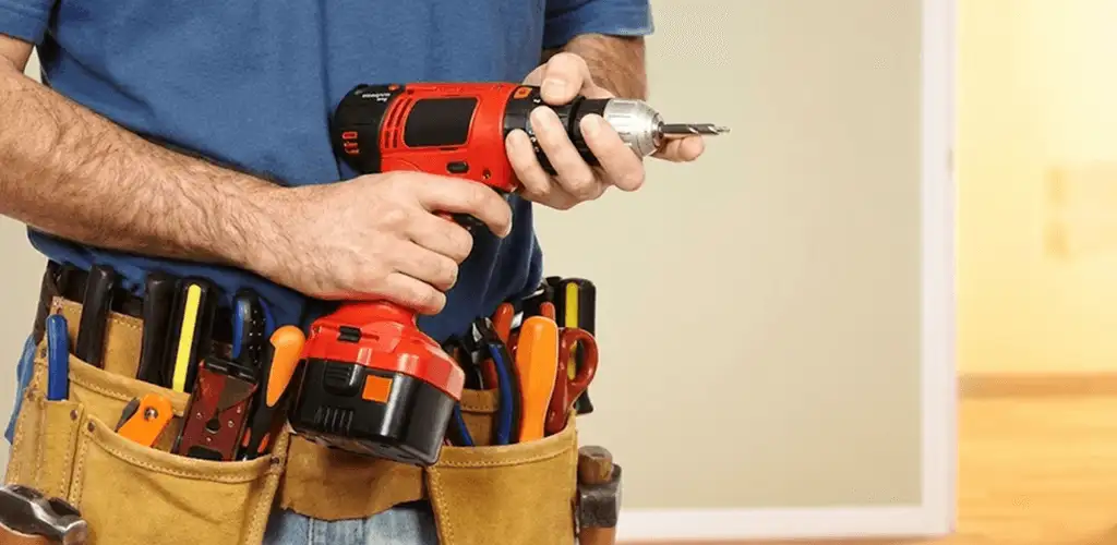 Handyman holding a power drill for home repairs and installations in Salt Lake City, UT